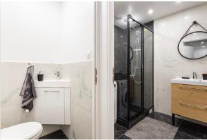 a bathroom with a shower and a toilet and a sink at Amazing flat, Paris suburb, near Versailles ,Orly in Orsay