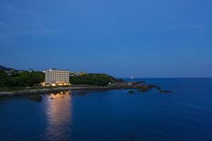 a building on a island in the water at night at Fairfield by Marriott Wakayama Kumano Kodo Susami in Susami