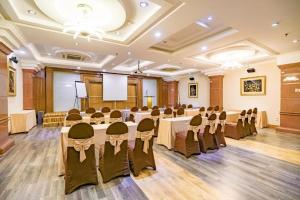a conference room with tables and chairs and a podium at Adina 3 Star Hotel in Danang