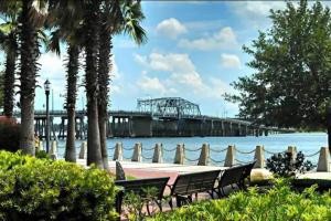 a view of a pier with palm trees and water at Cozy Marine Corps Home Near MCRD w/ a Beach Pass in Beaufort