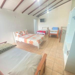 uma sala de estar com duas camas e um sofá em Barra da Lagoa Guest House em Florianópolis