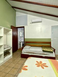 a bedroom with a bed and a bathroom at Barra da Lagoa Guest House in Florianópolis