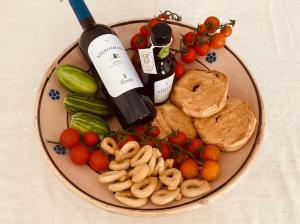 a plate of food with a bottle of wine and vegetables at La Racioppola in Ostuni