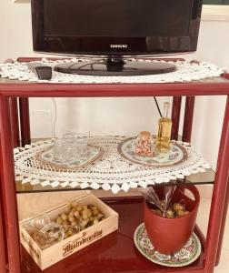 a shelf with a microwave and a box of food at La Racioppola in Ostuni
