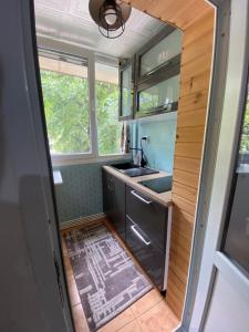 a small kitchen with a sink and a stove at The Urban Hub 1 in Iaşi