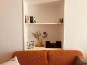 a room with a couch and a shelf with books at La Racioppola in Ostuni