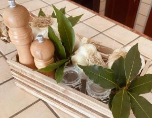 a wooden box with onions and a plant on a table at La Racioppola in Ostuni