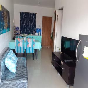 a living room with a table and a television at Transient with bedroom near Padre Pio Church in San Felix