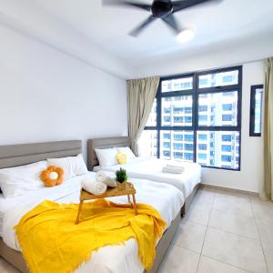 two beds in a room with a window at Atlantis residence #2Bedroom #2-8Pax in Melaka