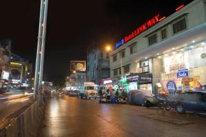 a busy city street at night with cars and buildings at Hotel Linkway in Mumbai