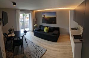 a living room with a couch and a table at Anna & Paul Appartements in Söll
