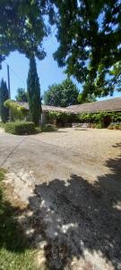 a house with a large driveway in front of it at Las Cafourques Chambre d'Hotes in Ségalas