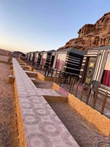 a row of buildings in the middle of the desert at The sunset of Wadi Rum in Wadi Rum