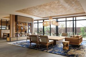 a living room with a dining table and chairs at Fairfield by Marriott Gifu Seiryu Satoyama Park in Minokamo