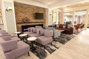 a lobby with couches and chairs and a fireplace at Four Points by Sheraton York in York