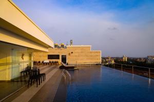 a swimming pool on the roof of a building at Hotel The Sea View, Mangalore in Mangalore