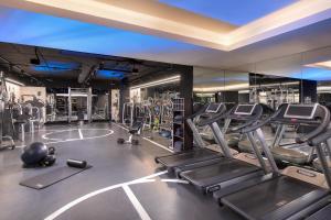 a gym with several treadmills and ellipticals at The Westin Valencia in Valencia