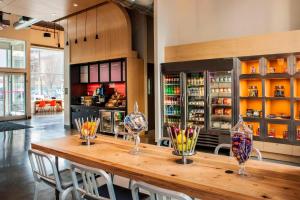 a large wooden table with chairs in a room at Aloft Long Island City-Manhattan View in Queens