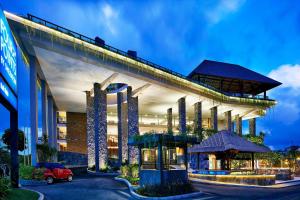 a building with a car parked in front of it at Four Points by Sheraton Bali, Kuta in Kuta