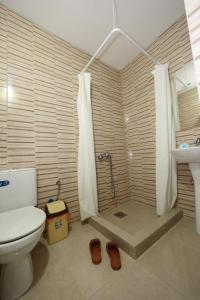 a bathroom with a toilet and a shower and a sink at Villa Rita in Ohrid