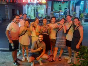 a group of people posing for a picture at Napoli Hostel in Cat Ba