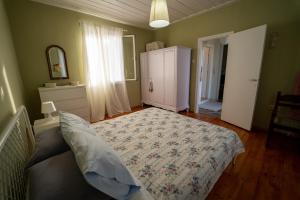 a bedroom with a bed and a dresser and a window at Lazarus Private House in Sami