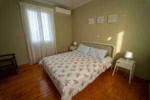 a bedroom with a bed and a table and a window at Lazarus Private House in Sami