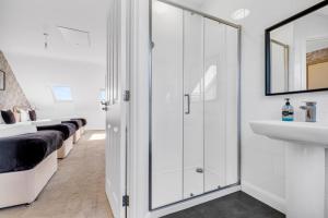 ein weißes Badezimmer mit Waschbecken und Spiegel in der Unterkunft City Centre 3 Bedroom House - Family & Business in Birmingham + 60 Fotos