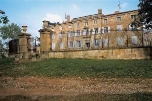 a large brick building with a fence in front of it at Firminy, centre-ville. in Firminy