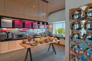 a kitchen with a table with food on it at Aloft College Station in College Station
