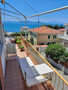 a balcony with benches and a view of the ocean at Il Balcone sull'Elba in Piombino +17 photos