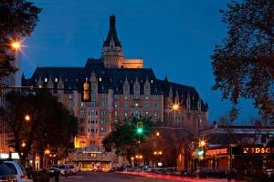 a large building with a tower on top of it at night at Delta Hotels by Marriott Bessborough in Saskatoon