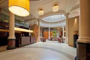 a lobby of a hotel with a large ceiling at Threadneedles, Autograph Collection in London