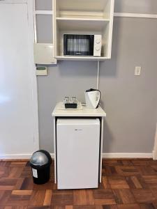 a white counter in a kitchen with a microwave at 28 ON WOOD in Pietermaritzburg