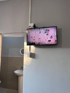 a flat screen tv on the wall of a bathroom at 28 ON WOOD in Pietermaritzburg