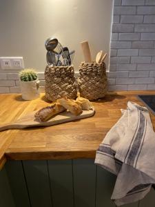 a wooden counter with bread and utensils on it at Pretty Historical Village House in Grimaud