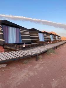 a row of benches sitting in the desert at Discover the life of Wadi Rum in Wadi Rum