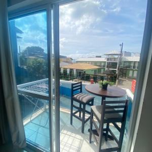 a view of a balcony with a table and chairs at GH Barra da Lagoa in Florianópolis