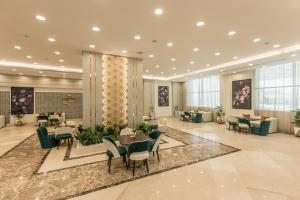 Tolip Resort Sunrays New- Alamein في العلمين: لوبي فيه طاولات وكراسي في مبنى