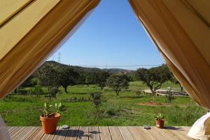 a view from a tent looking out at a field at Lost Paradise - A night into the Alentejo! in Sabóia