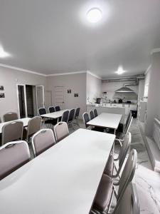 a conference room with tables and chairs in it at Hostel_inJoy in Shymkent