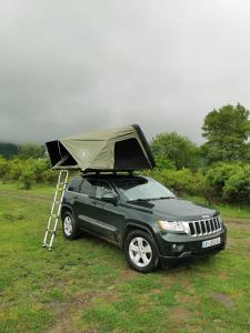 a jeep with a tent on top of it at Rent4travel in Tbilisi City