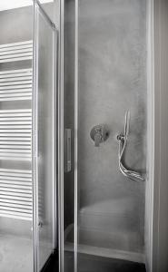 a shower in a bathroom with a glass door at Ca Bussun in Domodossola