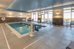 a swimming pool in a large building with at Fairfield Inn & Suites by Marriott Sidney in Sidney