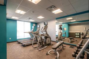 a gym with treadmills and ellipticals in a room at Fairfield Inn & Suites by Marriott Sidney in Sidney