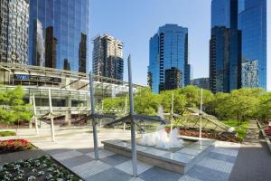 a park with a fountain in front of a building at Sheraton Vancouver Wall Centre in Vancouver