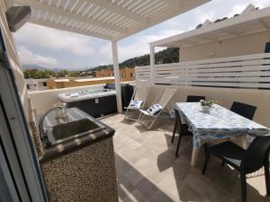 a patio with a sink and a table on a balcony at MARE e Terra Holiday fronte mare in San Vito lo Capo