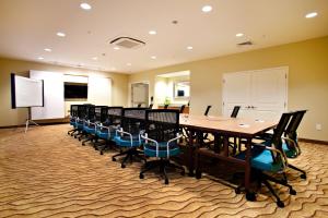 TownePlace Suites by Marriott Fort Walton Beach-Eglin AFB في شاطئ فورت والتون: قاعة المؤتمرات مع طاولة وكراسي طويلة