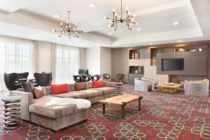 a living room with a couch and a tv at Four Points by Sheraton Fargo Medical Center in Fargo