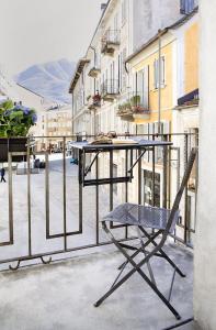 a table and a chair sitting on a balcony at Ca Bussun in Domodossola